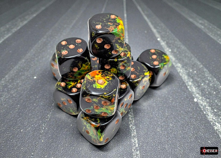 Set of black Chessex dice with a forest-like brush pattern and gold pips on a textured surface