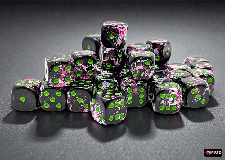 Set of dice with black, pink, and green design on a dark surface