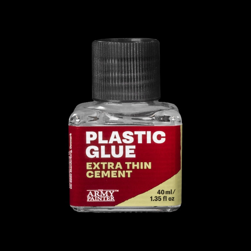 Bottle of Amy Painter plastic glue with a red label on a black background