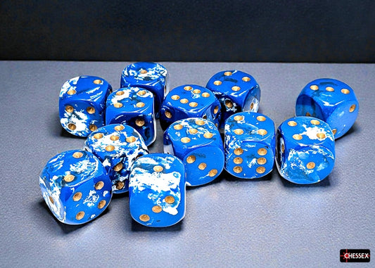 Blue dice with a ocean wave brush pattern and gold pips on a gray surface
