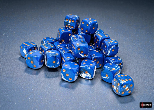 Blue dice with a brushed ocean wave and gold pips on a gray surface, featuring the Chessex brand.