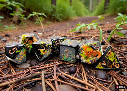 Set of Chessex dice with black, green, and orange design on a forest floor background