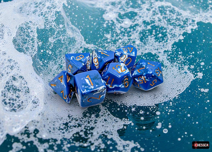 Blue polyhedral dice set with a brushed wave effect with gold numbers on a wave-painted surface