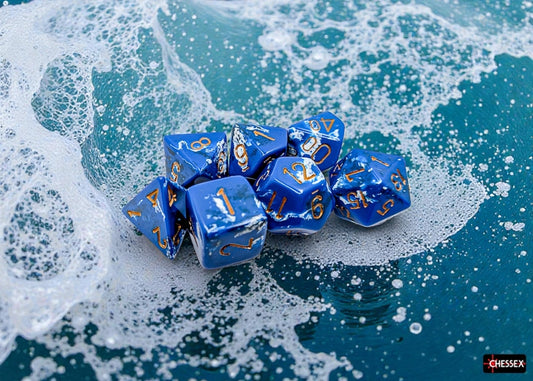 Blue polyhedral dice set with a brushed wave effect with gold numbers on a wave-painted surface