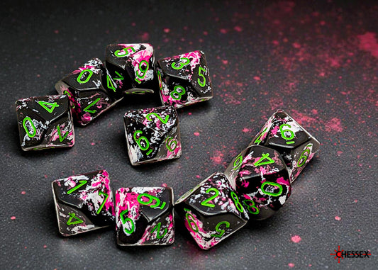 Set of black dice with a brushed effect of pink and white with green numbers on a dark background