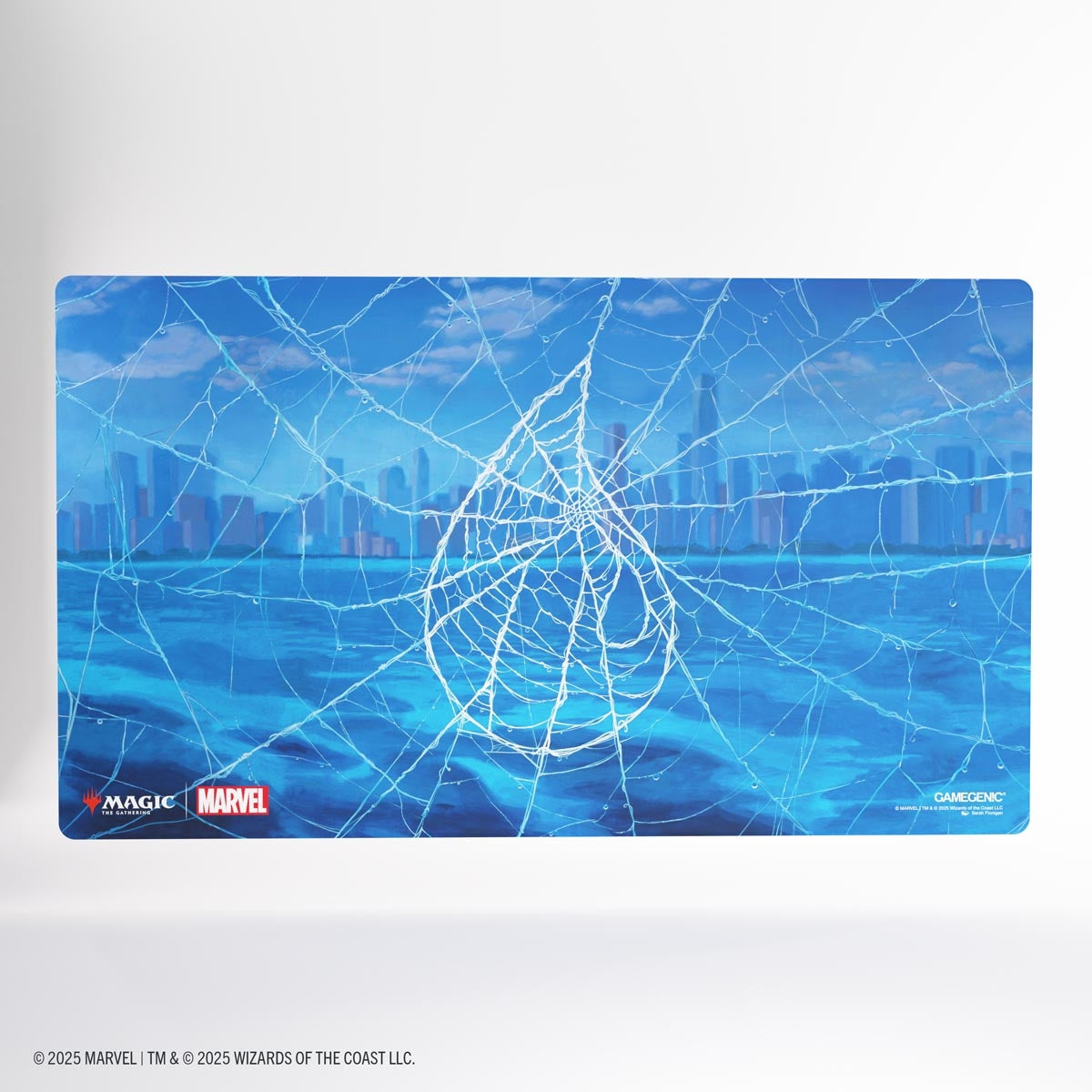 Playmat with spider web Island design and cityscape, featuring Marvel and Magic: The Gathering logos.