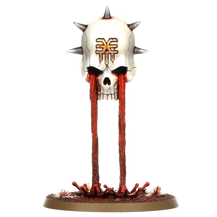Skull figurine with spikes and red liquid on a white background