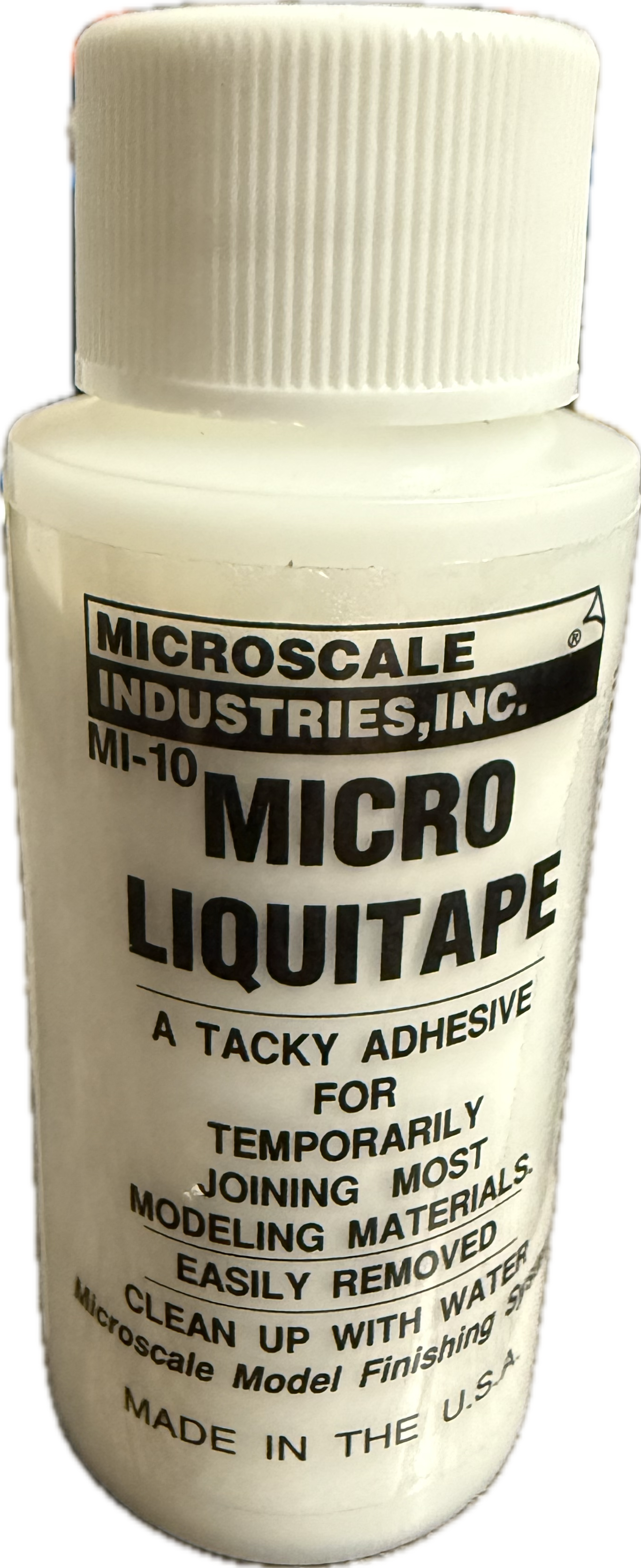 Bottle of Micro Liquitape adhesive with label on a white background