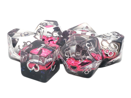 Clear dice with pink and black designs on a white background