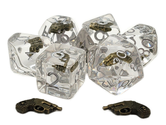 Clear dice with brass gun designs on a white background