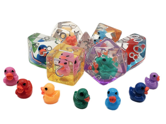 Colorful transparent dice with small rubber duck toys on a white background