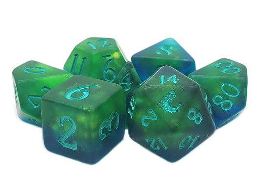 Set of green and blue polyhedral dice with numbers on a white background