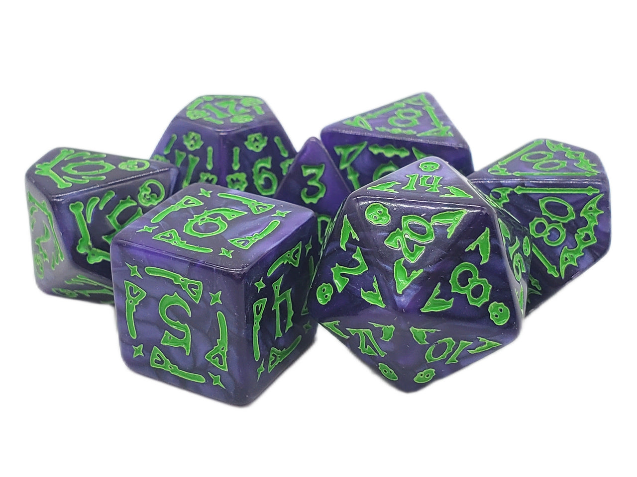 Set of purple polyhedral dice with green numbering on a white background