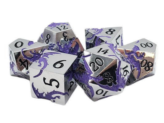 Set of metallic dice with dragon design on a white background