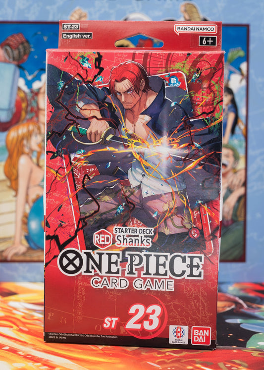 One Piece Card Game Starter Deck ST-23 featuring Red-Haired Shanks, English version by Bandai Namco, dynamic packaging with red and black design and lightning effects, for ages 6 and up.