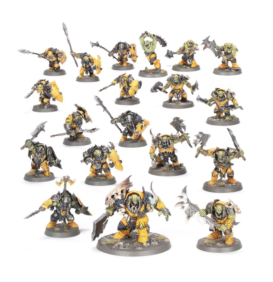 Collection of miniature figures with a mix of green, yellow, and gray colors on a white background.