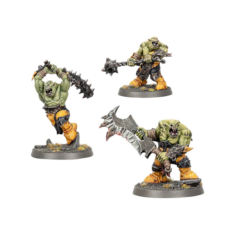Three fantasy miniatures of green-skinned warrior figures with armor and weapons on a white background