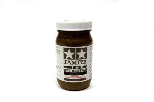 Tamiya brand paint jar with soil effect on a white background